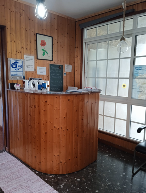 Welcoming reception desk with wood paneling and WiFi